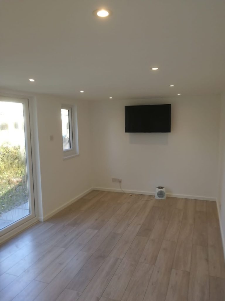Garden room with TV and wooden floor